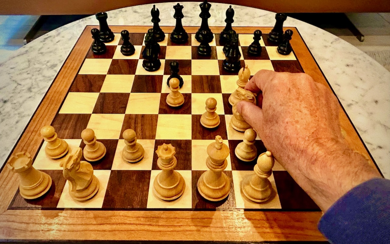 A knight held above the Liminal Chess board